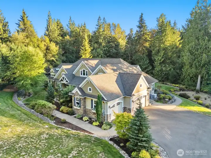 This angle shows the oversized 3-car garage and extra driveway parking.  Garage is heated with high ceilings and expanded storage areas.