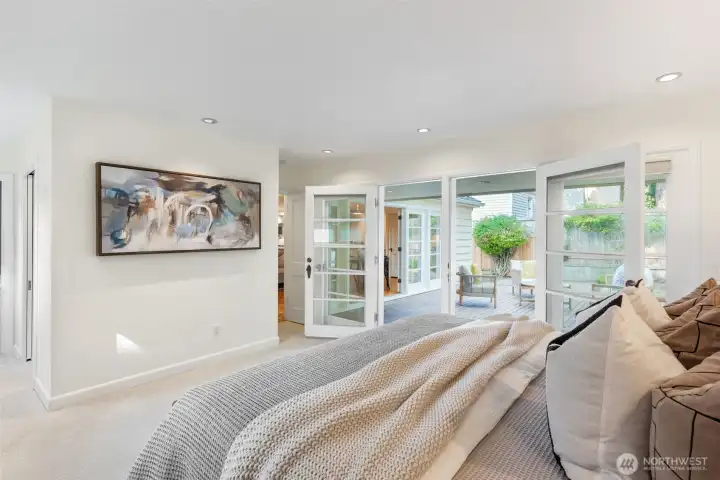 Primary bedroom with double doors to the deck.