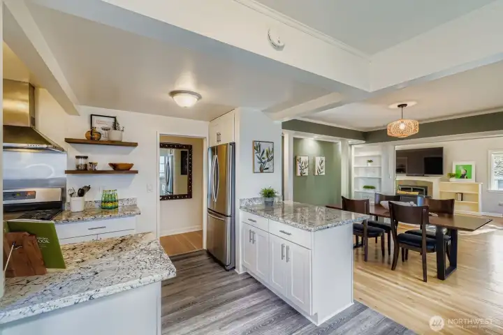 . The updated kitchen features sleek finishes, stainless steel appliances, and ample storage, opening effortlessly to the dining area for easy gatherings and everyday living.