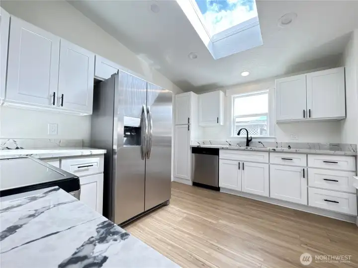 Kitchen with all new cabinets, quartz countertops, fridge, microwave, stove, sink, faucet. You don't have to do a thing!
