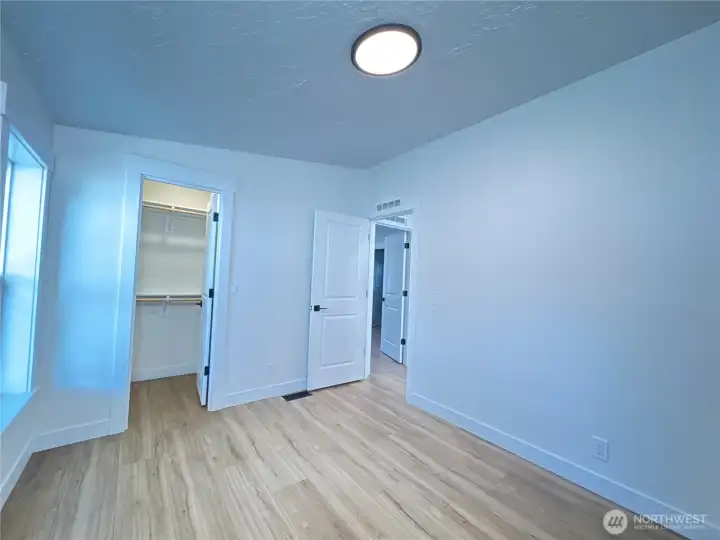 Secondary bedroom. All new floors, new windows, new light fixture, new closet kit, freshly painted.
