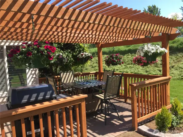 ..as you entertain guests enjoying the backyard fire pit beneath the charming pergola.