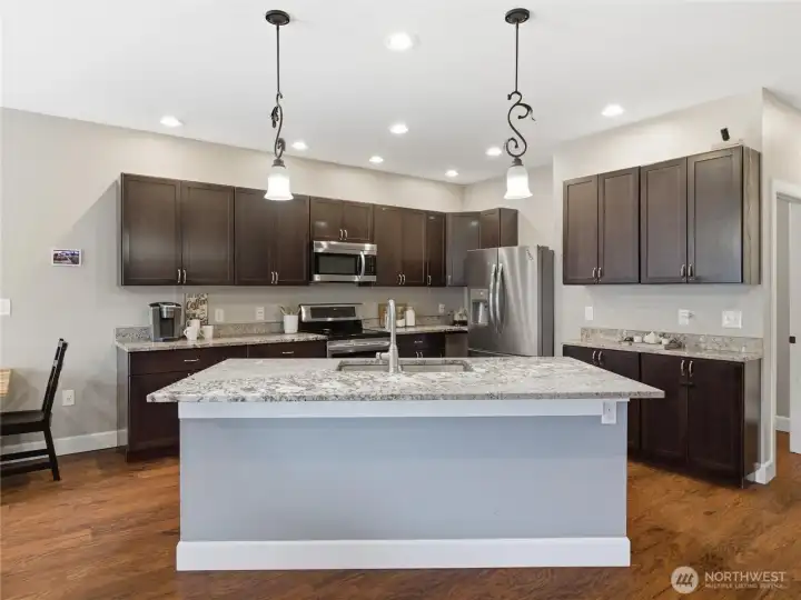 Corner style kitchen with oversized island- room for barstools to add extra convenient seating