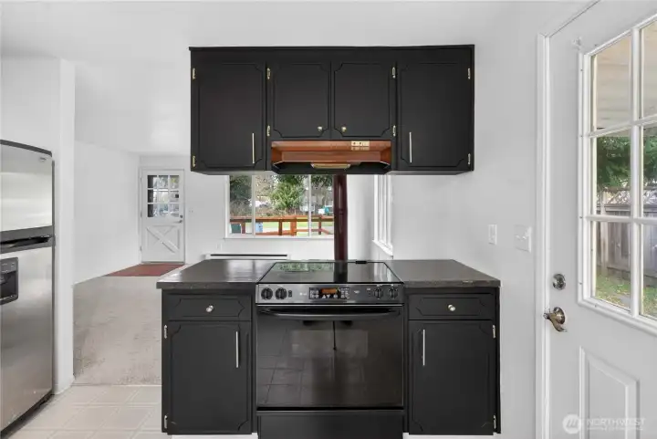 Beautifully designed cabinets with modern hardware, connecting seamlessly to the covered patio via a side door.