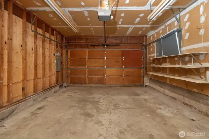 Spacious two-car garage offering ample room for parking, storage, and hobbies, complete with a dedicated workshop area for added versatility.