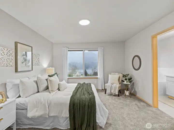 Across the house is the primary bedroom. You'll want to spend so much time in here relaxing with these stunning views.