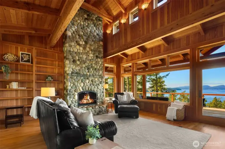 Dramatic floor-to-ceiling river rock wood-burning fireplace