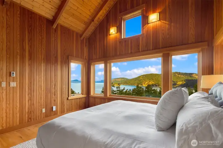 Main floor primary bedroom with vaulted ceilings and views straight through to Canada.