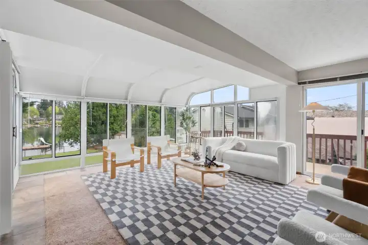 Atrium style windows in the main level living room give you views of the lake