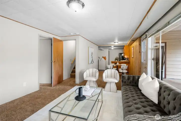 Lower level, living room looking towards kitchen and the stairs that lead up to main level.