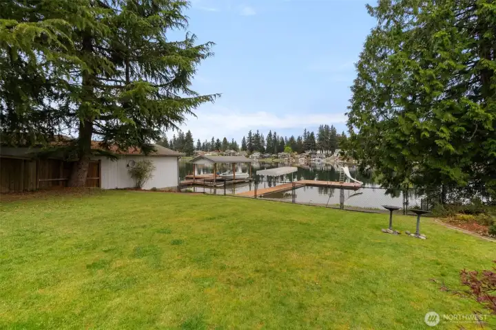 Large level backyard.  The fence along the waterfront beach was designed to be removed as needed.  Great for keeping pets and littles safe from the water, but easily removed for when you want open access to your sandy beach and dock.