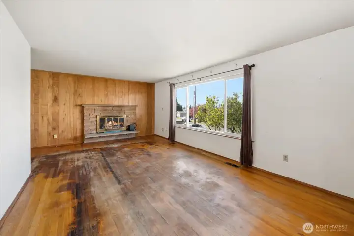 Living room in main home with woodburning fireplace