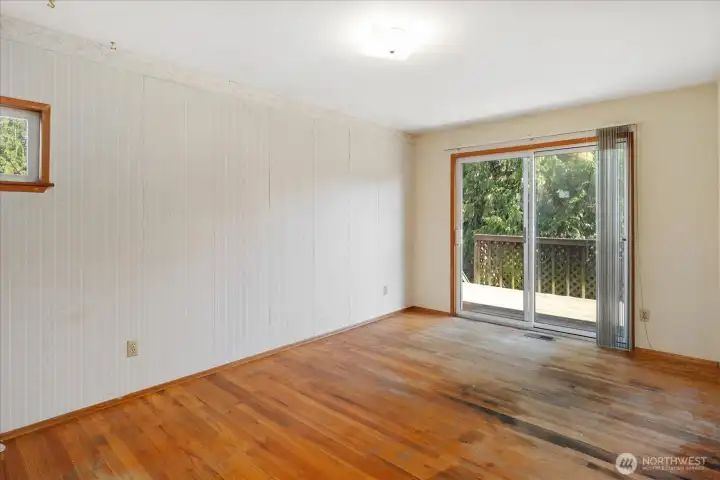 Primary bedroom in main home with sliding door to back deck