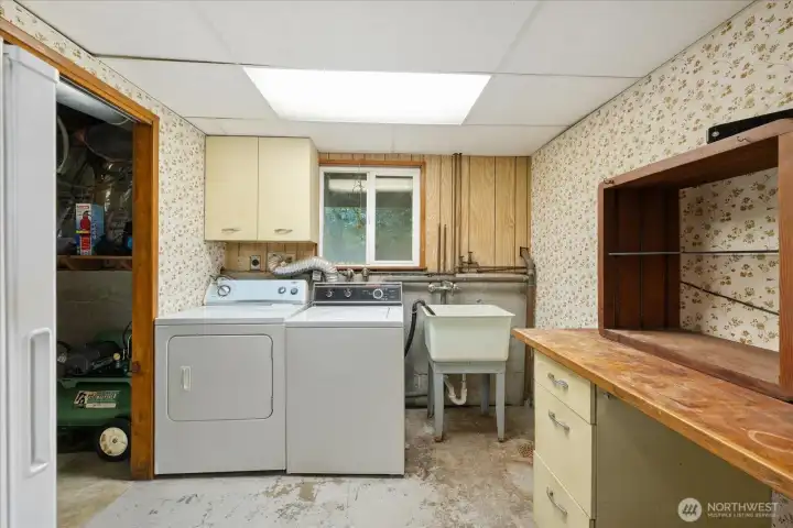 Laundry and utility room in the main home with plenty of room for an extra fridge/freezer