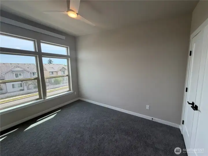 Picture of 680 W Kline Rd. Main bedroom with large transom windows, ceiling fan & French doors to closet