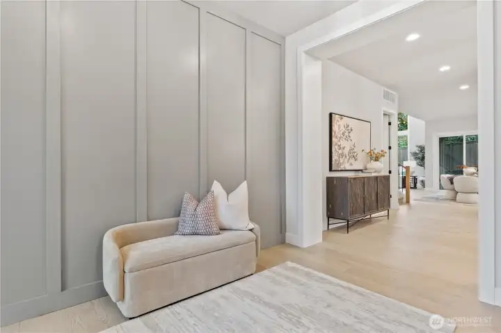 Spacious entry foyer features a millwork accent wall with subtle color contrast
