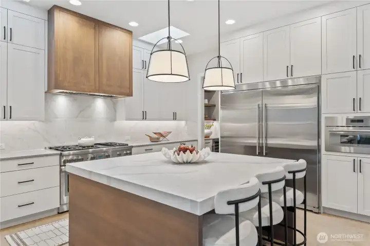 Gorgeous chef's kitchen with everything you'd expect to see, including six burner 48" gas range and 66" refrigerator/freezer