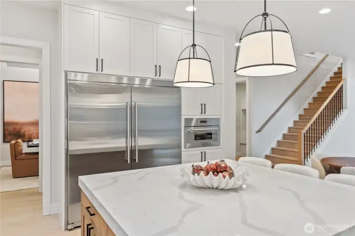 Generous island with contrasting cabinet color and bartop seating