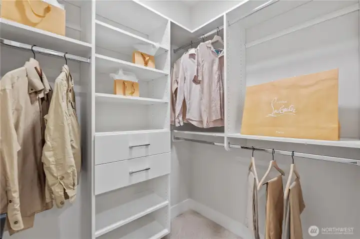 One of two walk-in closets with custom organizers