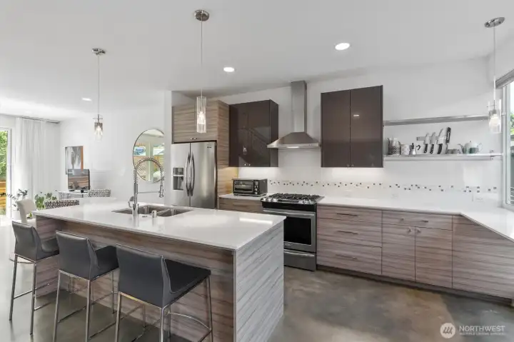 Open and airy main level features high ceilings, sleek concrete heated flooring, modern design, bright interiors, ample windows, and oversized glass doors that fill the space with natural light. Open and airy main level features high ceilings, sleek concrete heated flooring, modern design, bright interiors, ample windows, and oversized glass doors that fill the space with natural light.