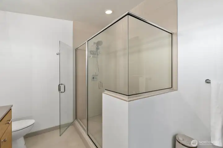 Primary bathroom featuring a double vanity, heated floors, an oversized shower, and thoughtful finishes throughout. Primary bathroom featuring a double vanity, heated floors, an oversized shower, and thoughtful finishes throughout.