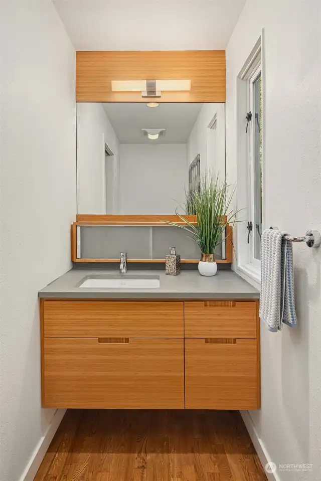The windowed main floor half bathroom also features Henrybuilt cabinets.