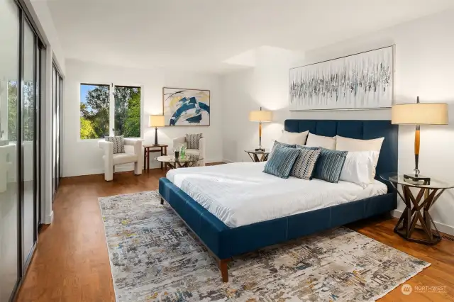 All four bedrooms are upstairs, including the enviously large primary suite. Two large closets with metal-framed, frosted sliding glass doors span the entire wall.