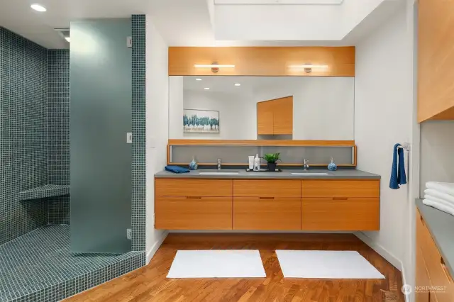 Truly spa-like, the primary bath is beautifully finished with floor to ceiling tiles & bench seat in the shower and double sinks.