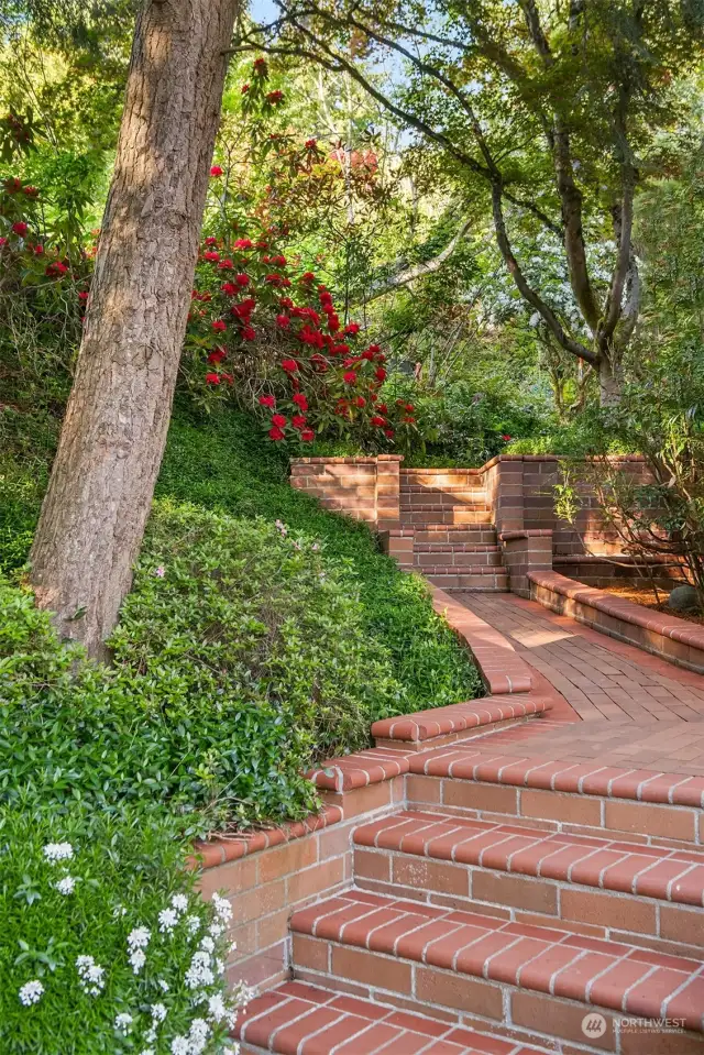 Take a peaceful and quiet walk up the brick path and around the house to enjoy all the gardens and mature plantings