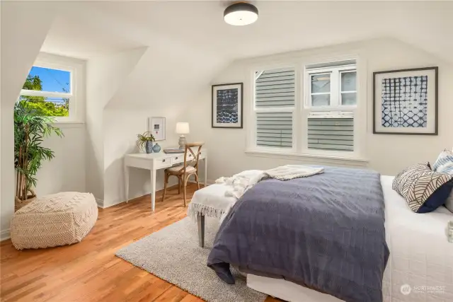 The third of the three bedrooms is also located upstairs and similarly boasts refinished hardwoods, 3 new windows, fresh paint and new lighting.