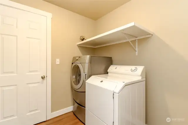 Large laundry room and entrance to garage