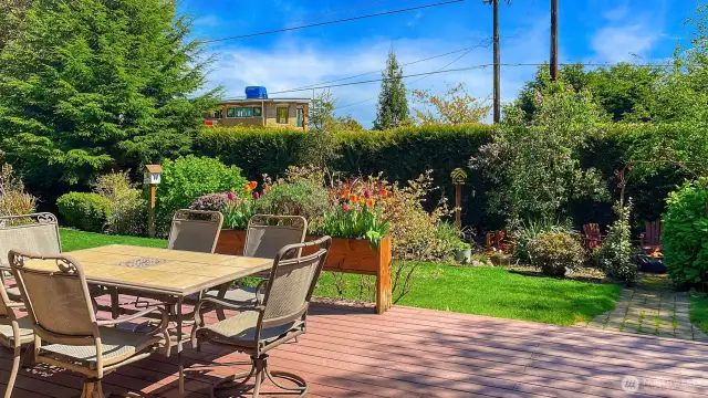 Sun catching deck across the back of the house. Room for multiple tables.