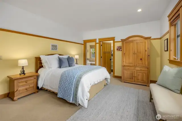 Upstairs Primary bedroom enjoys His and Hers closets and views over the front yard.