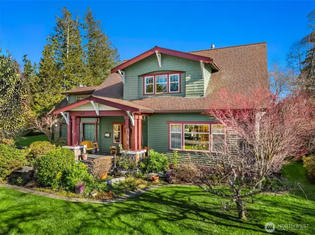 Fruit trees and beautiful mature landscaping surround the home.