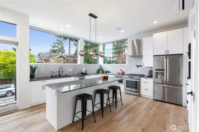 Beautifully designed kitchen with a sophisticated palette of tile and Quartz work surfaces. Large center island and breakfast bar, commercial quality gas range and SS appliances.