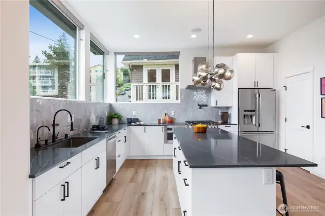 Additional kitchen details include Instahot water spigot, pot filler at the cooktop, ample storage, efficient under counter microwave drawer