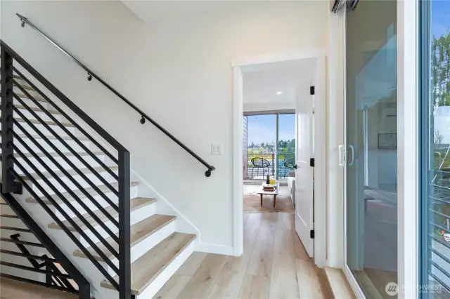 Top level staircase to primary suite level, multiple sliding doors + A/C.