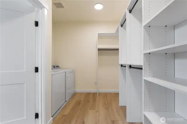 Primary walk-in closet with built-ins + washer/dryer