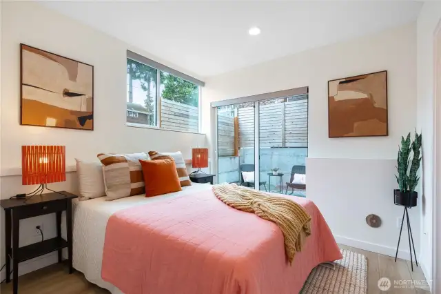 One of two first level bedrooms with double closets and private patio.