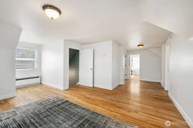 Upstairs Primary Bedroom looking toward entry, bath and two bonus rooms