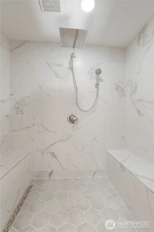 Rejuvenating walk-in floor to ceiling tiled shower.