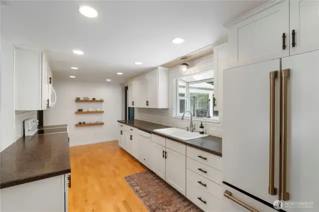 Kitchen also includes a single basin sink and garden window with a view of the backyard.