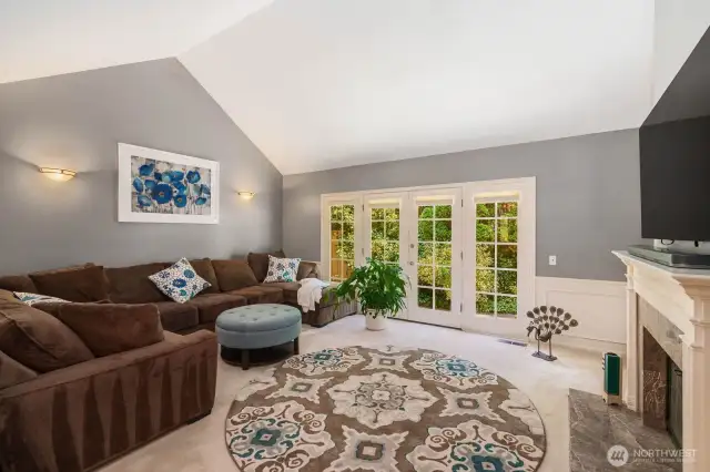 Living room features vaulted ceilings...