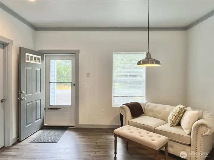 Great sized entry way. Currently being   staged as a sitting area, but would also work   with a large Dining Room Table