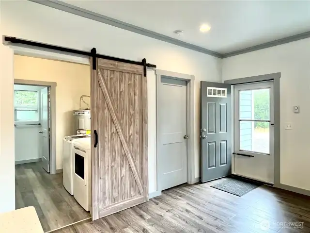 Entry with view of the Laundry/Mud room and access to quest bathroom and front bedroom.