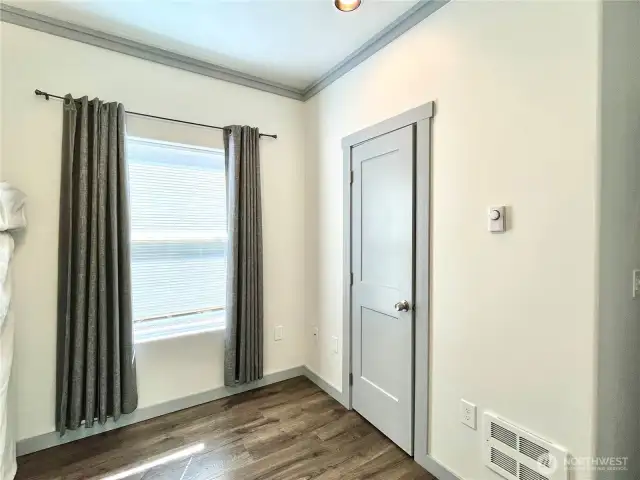 Front Bedroom and view of the window facing streetside. Comfotable ceiling fan and wall heater to keep you cozy