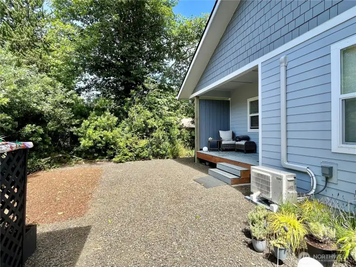View of the walk-in storage shed, back of   home and Mini Split Heater/ AC unit by the   deck steps
