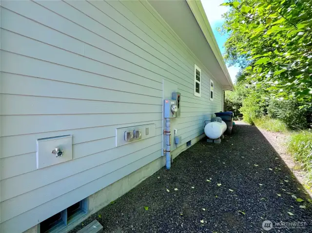 View of the North side of the home. Propane and convenient utiltiy connections here.