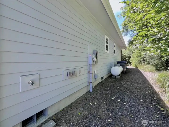 30 AMP Plug and View of the North side of   the home. Propane and convenient utiltiy   connections here