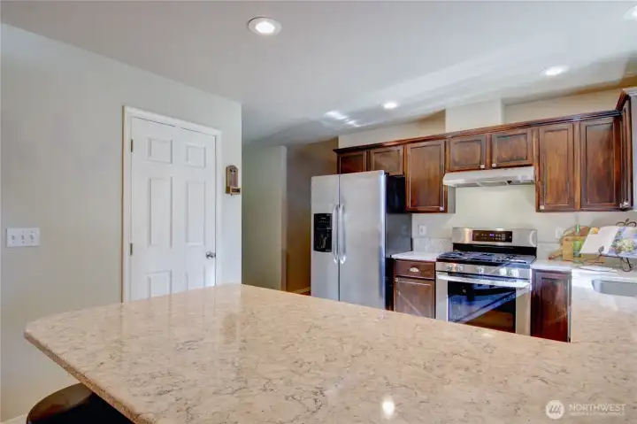 From the eating bar looking towards the spacious pantry, door on left.